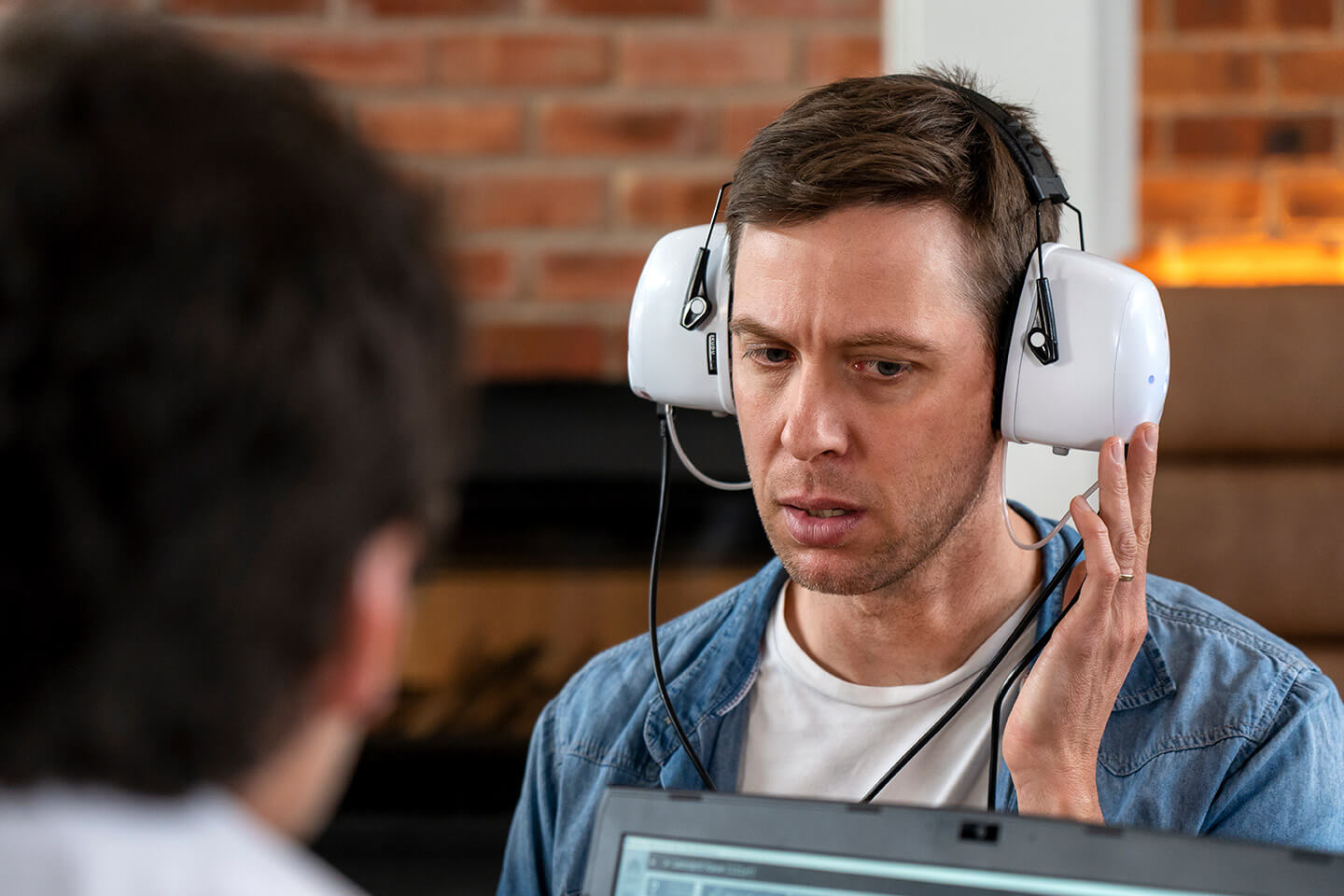 Patient undergoing a hearing test with a calibrated audiometer headset